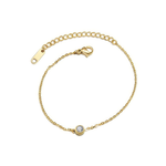 Gold bracelet with a small clear round gemstone on a white background