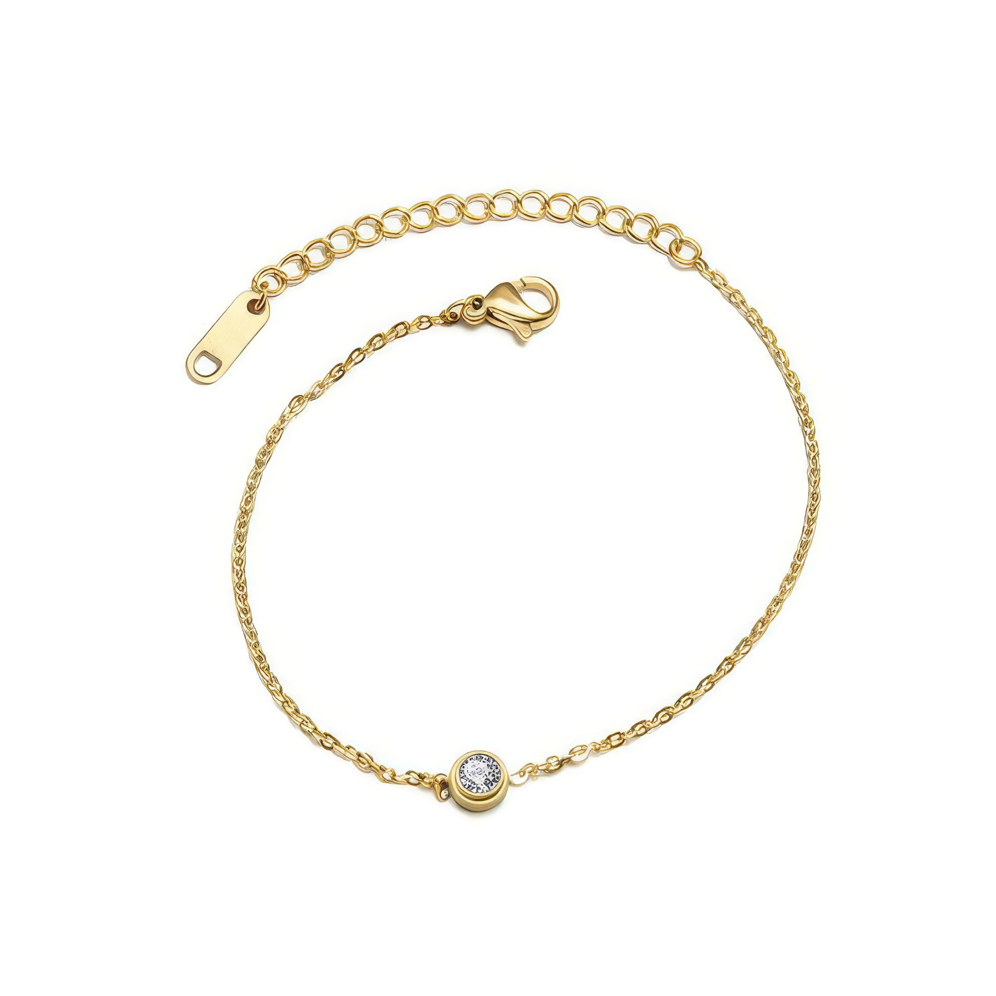 Gold bracelet with a small clear round gemstone on a white background