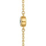 Side view of a clear gemstone on a gold chain against a white background