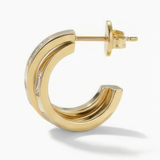 Side view of a gold hoop earring with white baguette stones on a white background