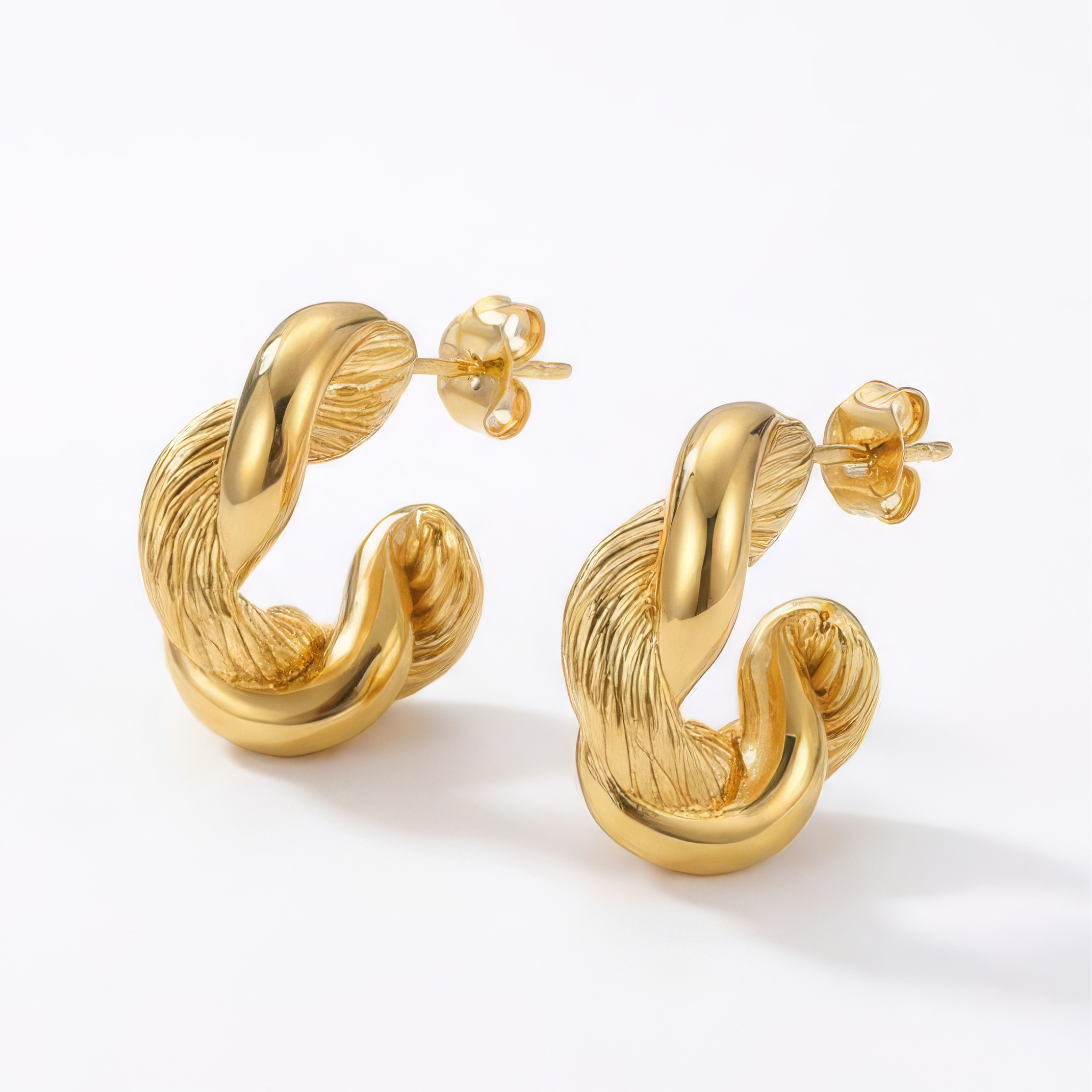 Gold hoop earrings on a white background