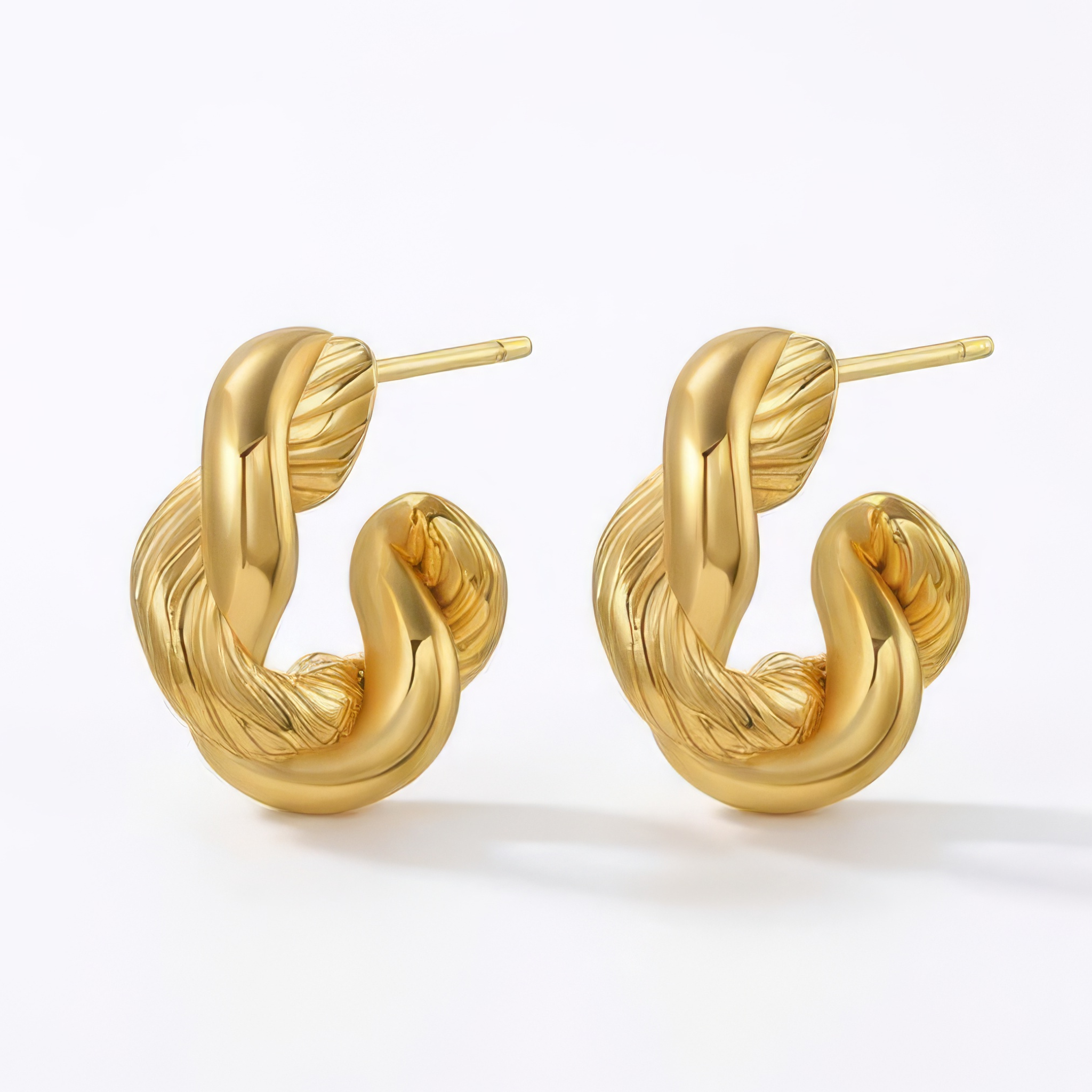 Gold hoop earrings on a white background