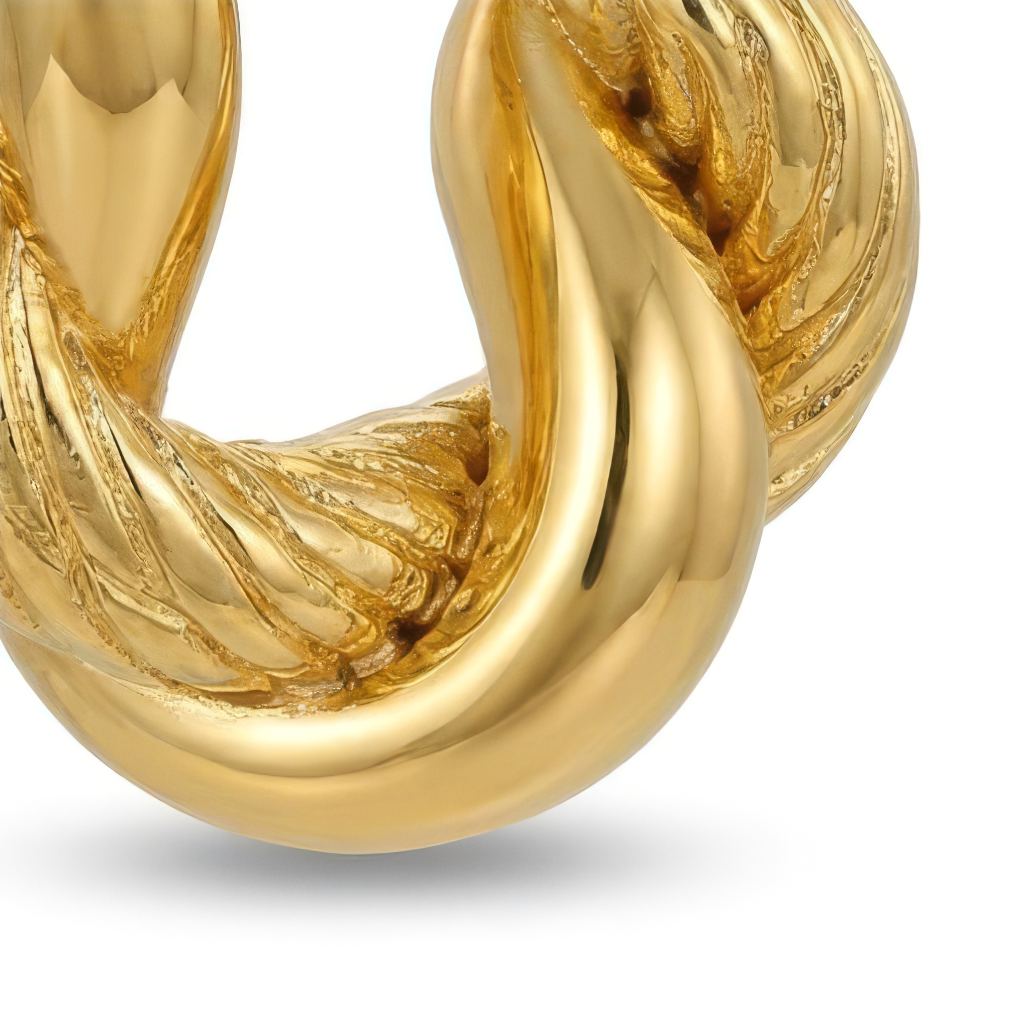 Closeup of a gold hoop earring on a white background