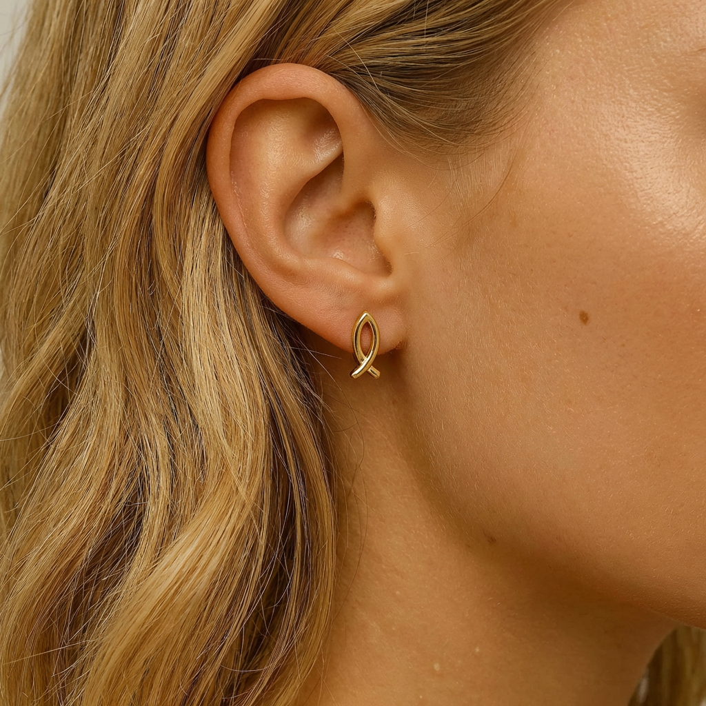 Close-up of a woman wearing a gold earring with blonde hair