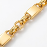 Close-up of a gold chain bracelet on a white background
