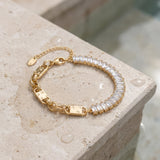 Gold bracelet with clear baguette gemstones on a textured stone surface