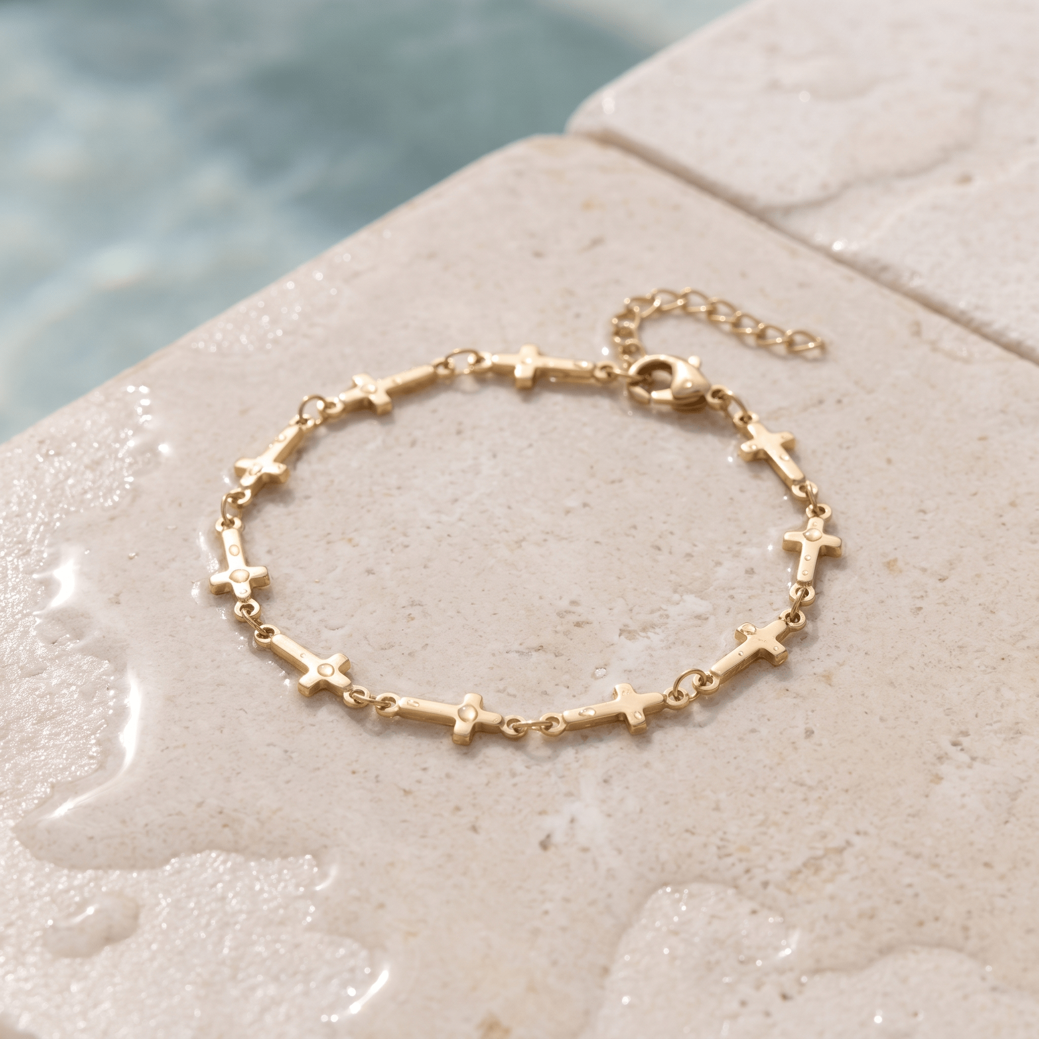 Mini Crosses Bracelet on the ledge of a pool