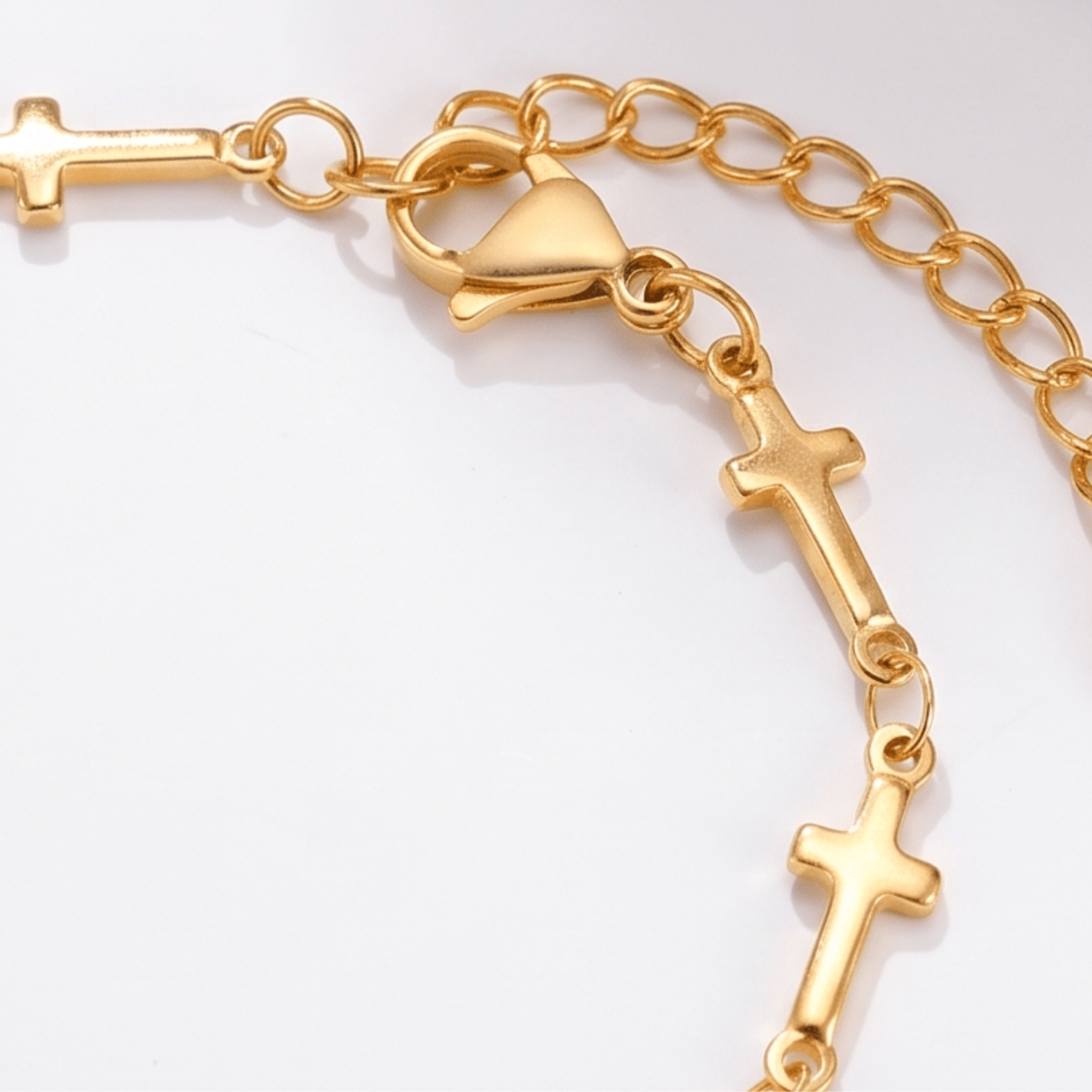 Close up of gold Mini Crosses Bracelet on a white background.