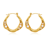 A pair of gold hoop earrings with six small irregular pearls embedded into the side of the hoops on a white background. 