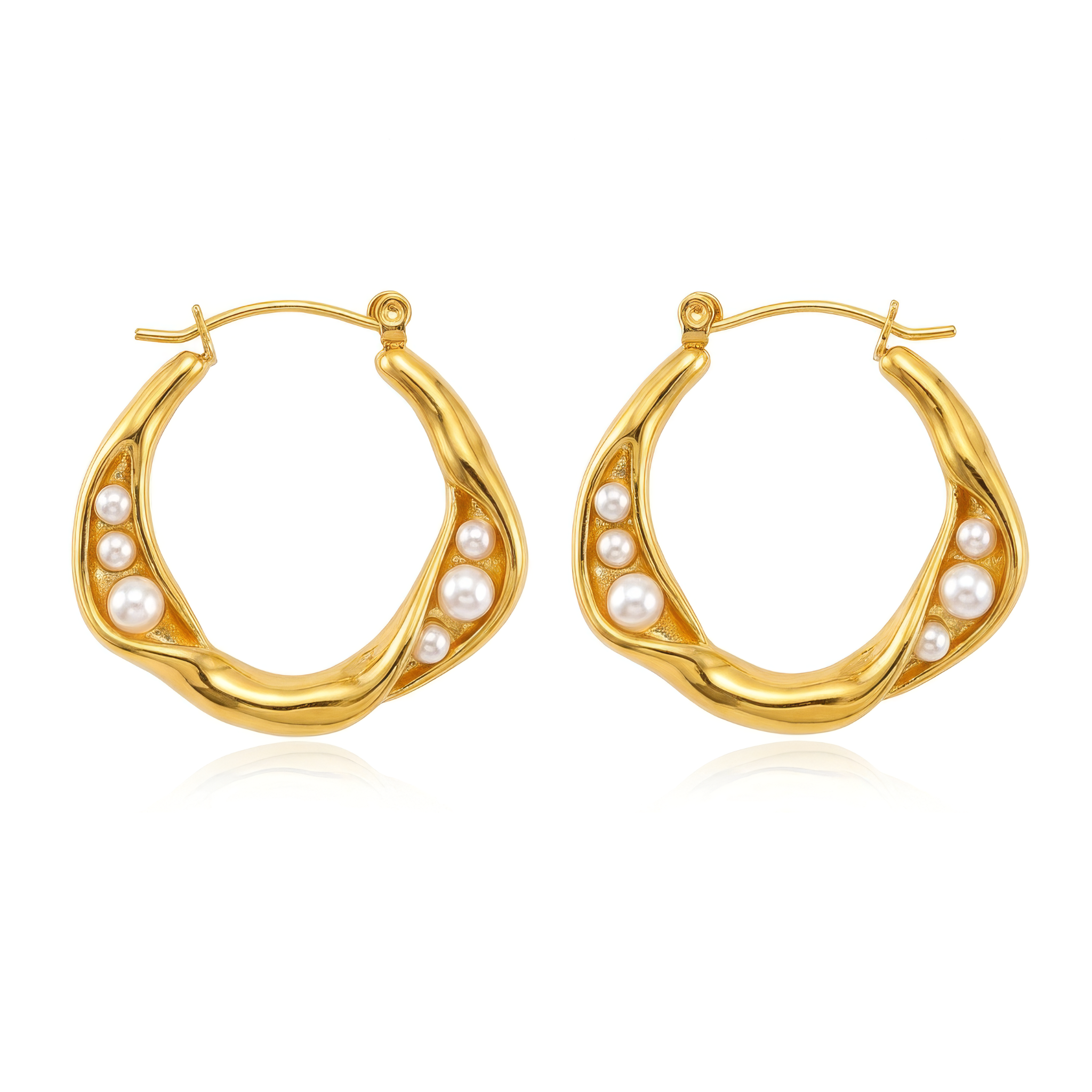 A pair of gold hoop earrings with six small irregular pearls embedded into the side of the hoops on a white background. 