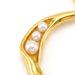 Gold ring with pearls on a white background