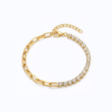Gold bracelet with clear gemstones on a white background