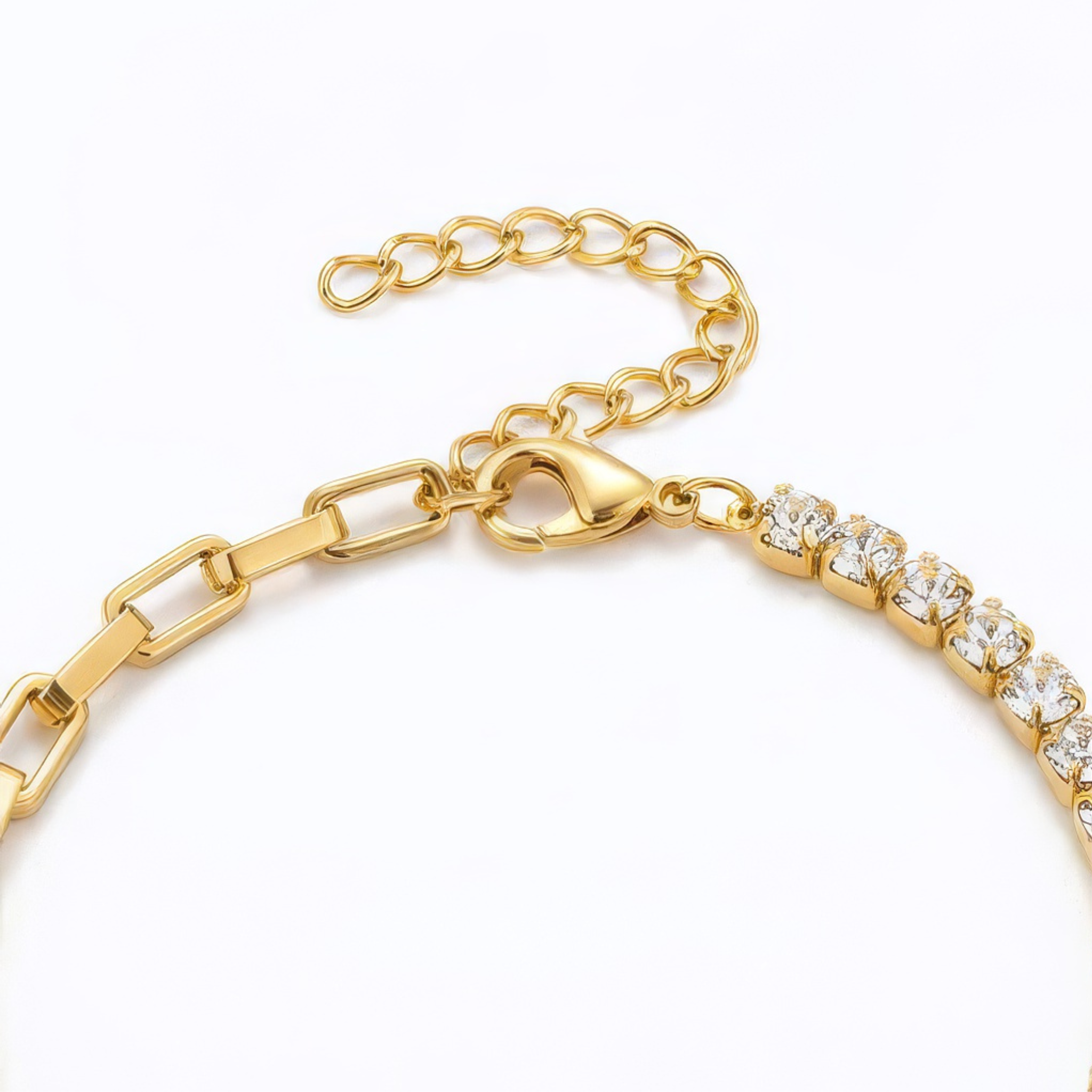 The clasp of a gold bracelet with clear gemstones on a white background