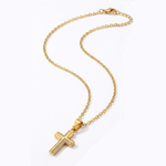 Gold cross necklace on a white background