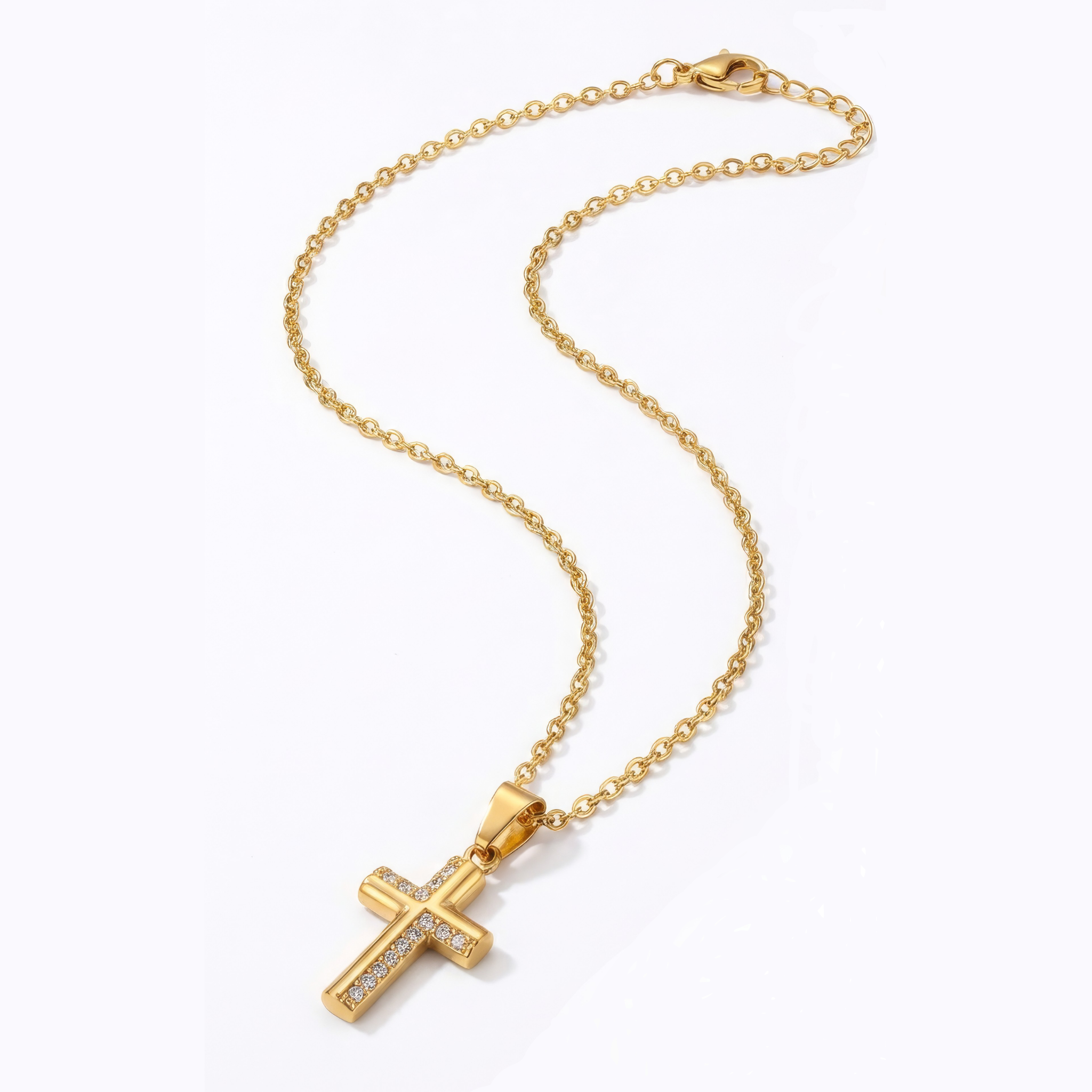 Gold cross necklace on a white background