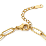 Close-up of the clasp of gold paperclip chain bracelet on a white background