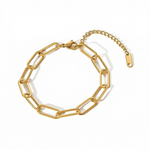 Gold paperclip chain bracelet close-up on white background
