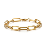 Close up of gold paperclip chain bracelet on a white background