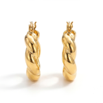 Front view of a pair of gold hoop earrings on a white background